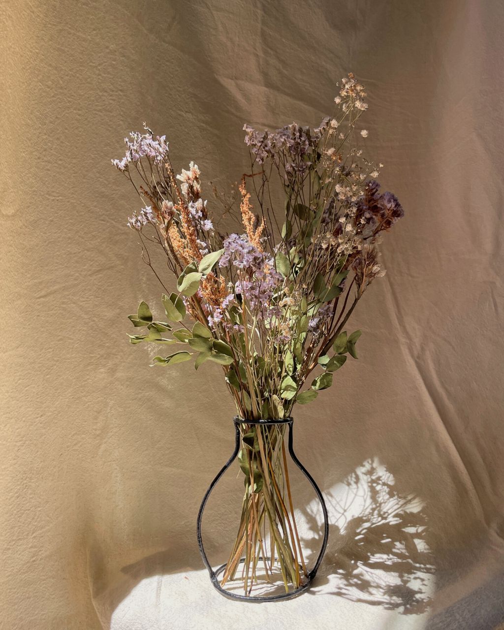 Florero minimalista de hierro negro de 15 cm de alto, con flores secas de larga duración.